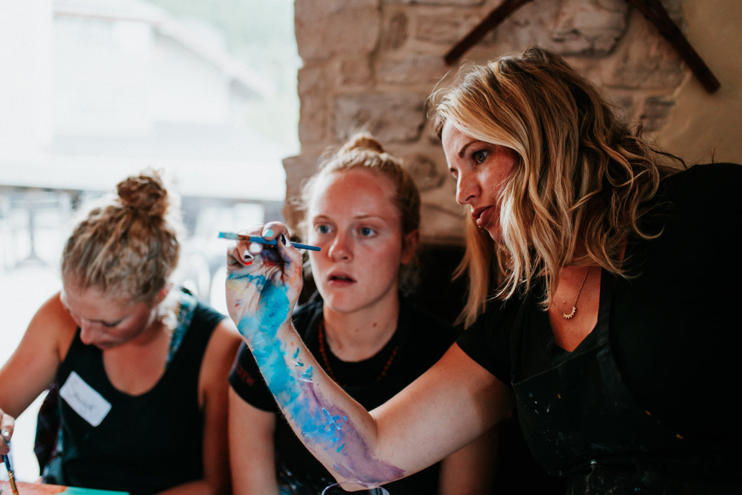 Whistler artist Andrea Mueller teaches students during a Paint night